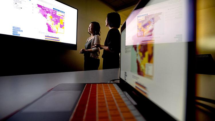 Dr. Scarlett Gomez, right, an epidemiologist and UCSF professor, examines Bay Area cancer rates using California Health Maps with UCSF data scientist Debby Oh on Wednesday, Oct. 2, 2019, at UCSF's Mission Bay campus.